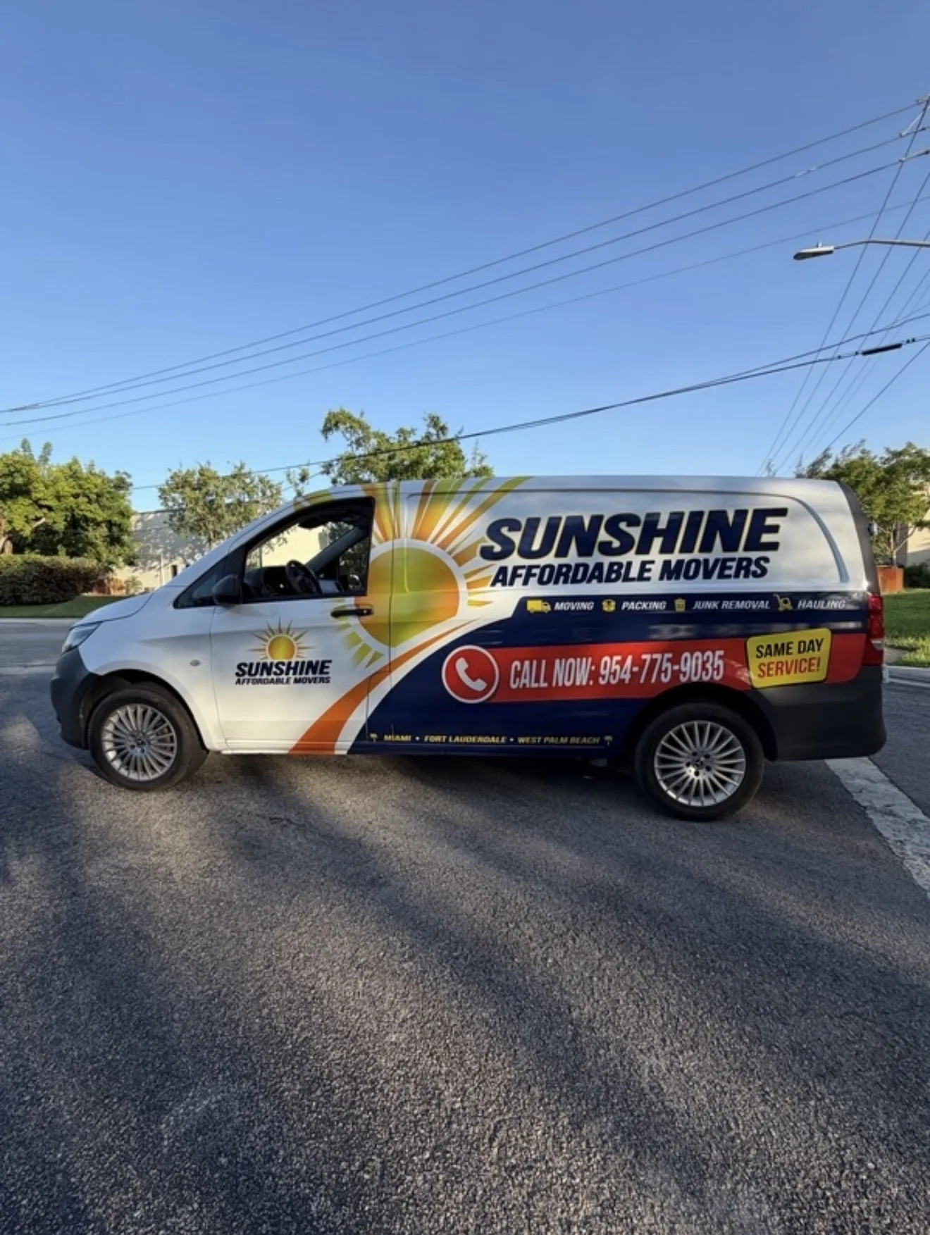 Sunshine Affordable Movers branded cargo van ready for event moving work.